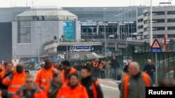 Люди покидают здание аэропорта в Брюсселе. 22 марта 2016 года.    