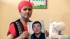 KAZAKHSTAN-CHINA-RIGHTS-XINJIANG-COURT Bikamal Kaken poses with a portrait of her disappeared husband Adilgazy Muqai in a rental apartment in the provincial town of Uzynagash, around 60 kilometres from Kazakhstan’s largest city Almaty, on August 27, 2020.