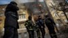 Firefighters work to put out a fire at a residential building hit by a Russian military strike in Bakhmut on December 7.