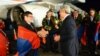 Armenian President Serzh Sarkisian (right) greets members of the Armenian men's chess team at Yerevan's Zvartnots airport.