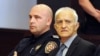 Former Serb paramilitary commander Dragan Vasiljkovic (right), aka "Captain Dragan," in court on September 20. 