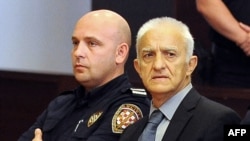 Former Serb paramilitary commander Dragan Vasiljkovic (right), aka "Captain Dragan," in court on September 20. 