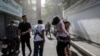 Iran -- People run along a street amid smoke following the Israeli strikes on Iran