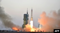 A Chinese Long March-2F carrier rocket transporting the manned spacecraft Shenzhou-11 blasts off from the launch pad at the Jiuquan Satellite Launch Center in Jiuquan, in northwestern China's Gansu Province, in October 2016.