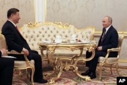 Президент Росії Володимир Путін та голова Китаю Сі Цзіньпін п'ють чай під час зустрічі в Кремлі в Москві, Росія, 8 травня 2025 року, напередодні святкування 80-ї річниці перемоги Радянського Союзу над нацистською Німеччиною у Другій світовій війні