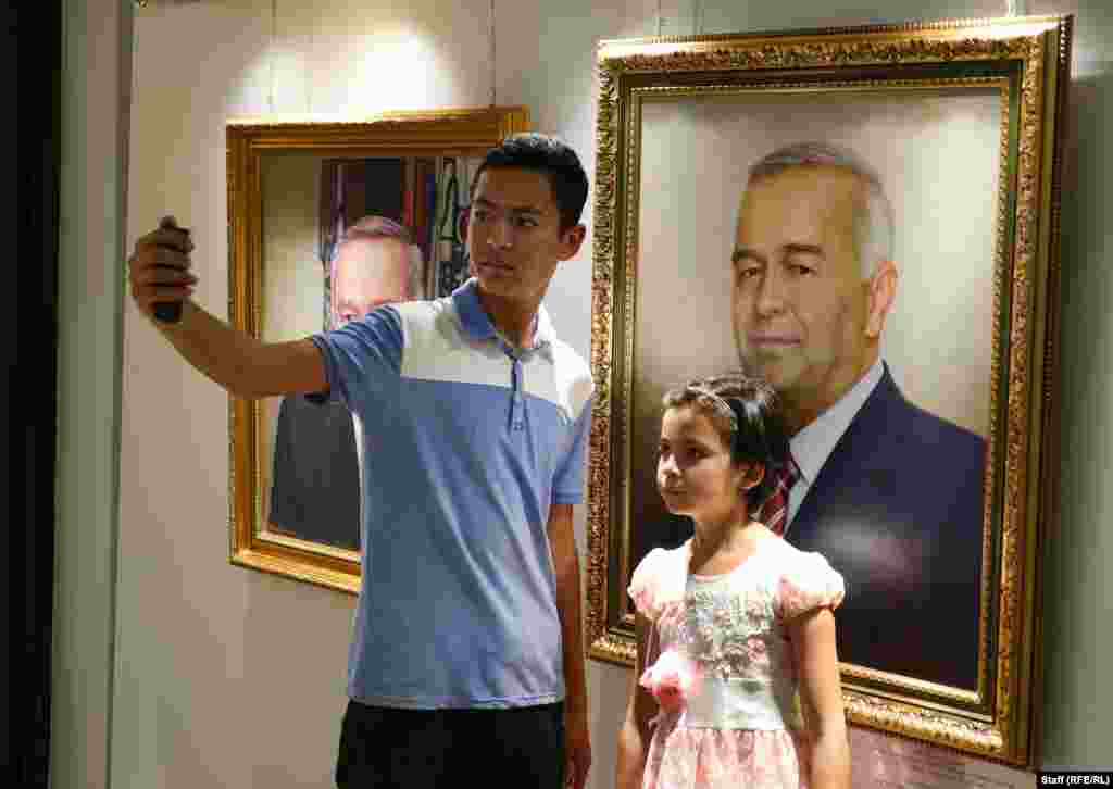 Музейге келгендер Каримовдун портреттеринин алдында өздөрүн сүрөткө тартып жатышат.&nbsp;