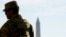 A member of the Louisiana National Guard patrols at the Lincoln Memorial on November 27, a day after two National Guard members were shot in Washington, D.C.