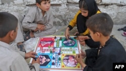 شماری از کودکان در حومه های شهر جلال آباد در روز عید لباس نو پوشیده و گیم بازی می‌کنند. عکس از آرشیف October 16,2013