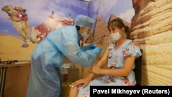 A woman receives a dose of the Sputnik V vaccine in a shopping mall in Almaty.
