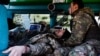 A medic treats a wounded Ukrainian soldier at a frontline stabilization ambulance in an undisclosed location near the frontline town of Kreminna, Ukraine, on March 13.