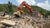 Recovery crews hunt for bodies among the ruins of a building in the village of Bishonai in Pakistan's Buner district on August 19 after floods swept through the region. 