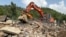 Recovery crews hunt for bodies among the ruins of a building in the village of Bishonai in Pakistan's Buner district on August 19 after floods swept through the region. 