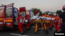 Rescuers work at the site of a fatal gas explosion in Crevedia, near Bucharest. 