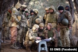 Soldiers from Ukraine's 53rd Mechanized Brigade pose for a replica image in January 2024.