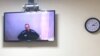 Russian opposition leader Aleksei Navalny is seen on a screen during a court hearing on May 31.