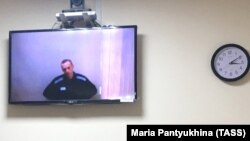 Russian opposition leader Aleksei Navalny is seen on a screen during a court hearing on May 31.