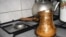 Armenia -- A gas stove with a coffee making ibriks on it, undated
