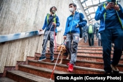 Nedu (right) and a friend walk with a companion dog in the Bucharest subway