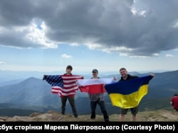 Волонтери Марцін Пйотровський і Марек Скулімовський з сином на вершині Говерли