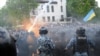 Ukraine - Supporters of nationalist parties throw a lit flare into ranks of riot police during a protest in Lviv during Victory day marking the anniversary of the end of WWII, 09May2011
