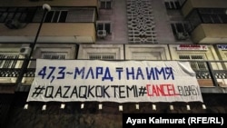 A group of activists say they placed the banner in Kazakhstan's biggest city to protest what they described as a "cult of personality" surrounding former President Nursultan Nazarbaev. 