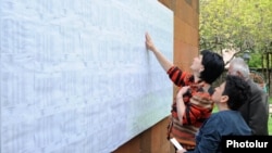 Armenia - Voters look for their names on electoral rolls posted outside a polling station in Yerevan, 6May2012.