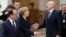 German Chancellor Angela Merkel (C) and French President Francois Hollande (L) say goodbye to Belarusian President Alyaksandr Lukashenka (R) as they leave the Ukrainian peace negotiations in Minsk, February 12, 2015