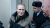 RUSSIA -- Dennis Christensen is escorted inside a courthouse following the verdict announcement in the town of Oryol, February 6, 2019