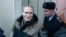 RUSSIA -- Dennis Christensen is escorted inside a courthouse following the verdict announcement in the town of Oryol, February 6, 2019