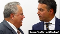 Macedonian Foreign Minister Nikola Dimitrov (right) and Greek Foreign Minister Nikos Kotzias in Skopje on August 31.