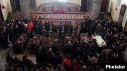 Armenia - The bodies of six murdered members of a family in Gyumri lie in state at a local church, 14Jan2015.