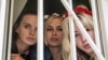 Активистки FEMEN Оксана Шачко, Александра Шевченко и Яна Жданова в ожидании приговора в здании суда в Киеве. 28 июля 2013 года