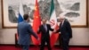 Chinese Foreign Minister Wang Yi welcomes Russian Deputy Foreign Minister Sergei Ryabkov (right) and Iranian Deputy Foreign Minister Kazem Gharibabadi (left) in Beijing, March 14