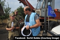 Наталя Мещерякова і представник ОБСЄ під час ремонту водогону, с. Зайцеве Донецької області, 2017 рік