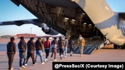 A photo released in January 2025 showing migrants in the US boarding a deportation flight.
