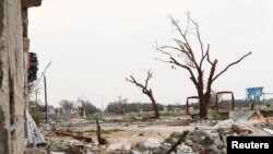 Зруйнована внаслідок бойових дій вулиця. Бенгазі, Лівія. 16 березня 2015 року