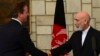 Afghan President Hamid Karzai (right) shakes hands with British Prime Minister David Cameron during a press conference at the presidential palace in Kabul on June 29.