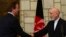 Afghan President Hamid Karzai (right) shakes hands with British Prime Minister David Cameron during a press conference at the presidential palace in Kabul on June 29.