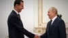 Russian President Vladimir Putin (right) meets with Syrian President Bashar al-Assad at the Kremlin in Moscow on September 13.
