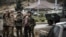 NAGORNO-KARABAKH -- Russian peacekeepers (R and 3rdR) stop a car at their checkpoint outside the city of Stepanakert, November 13, 2020