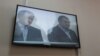 Монитор показывает подсудимого бывшего акима Карагандинской области Бауржана Абдишева (слева). Караганда, 10 августа 2015 года.