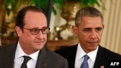 U.S. President Barack Obama (right) and French President Francois Hollande arrive for a joint news conference after their meeting at the White House on November 24.