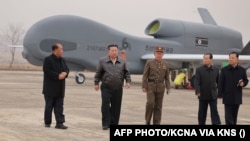 North Korean leader Kim Jong Un inspecting newly developed unmanned reconnaissance aircraft at an undisclosed location in North Korea. 