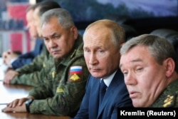 Russian President Vladimir Putin (center), Defense Minister Sergei Shoigu (left), and General Valery Gerasimov oversee a military exercise in September 2020.
