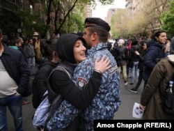 Protesters blocked a central crossroad in Yerevan. Around 60 police armed with nightsticks tried to hem them in, but with mostly young women in front, the police eventually gave up and retreated to a nearby courtyard.