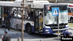 Police survey the scene after an explosion on a bus in Tel Aviv on November 21. 
