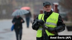 Bosnian police staged a nationwide manhunt to find the man behind the killing of at least two people last week. 