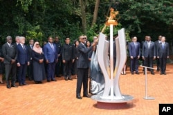 Rwandan President Paul Kagame lights a memorial flame during a ceremony to mark the 30th anniversary of the Rwandan genocide, held at the Kigali Genocide Memorial, in Kigali, Rwanda, on April 7, 2024.