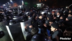 Armenian protesters clash with riot police on January 15 near the Russian Consulate in Gyumri, where the family was killed in their home.