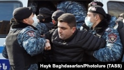 ARMENIA -- Police detain an opposition demonstrator during an anti-government protest in Yerevan, February 23, 2021